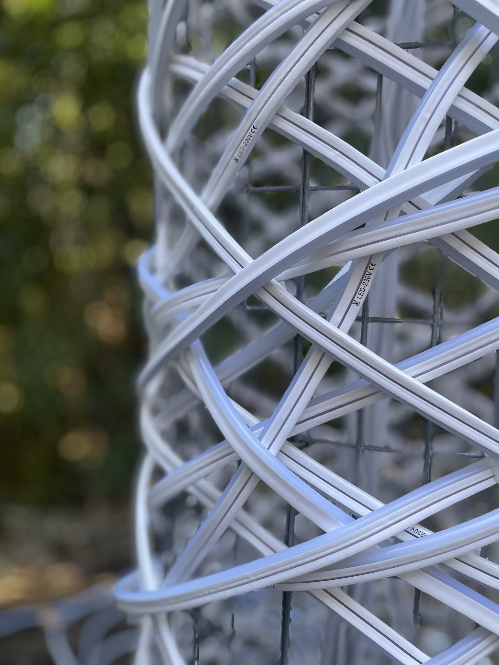 Unfolding Light, 2026 — detail of LED lines and wire basket